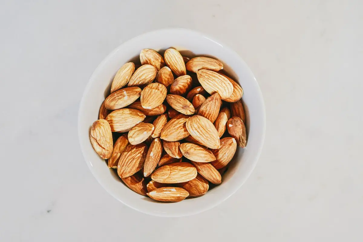 White bowl of almonds seen from above