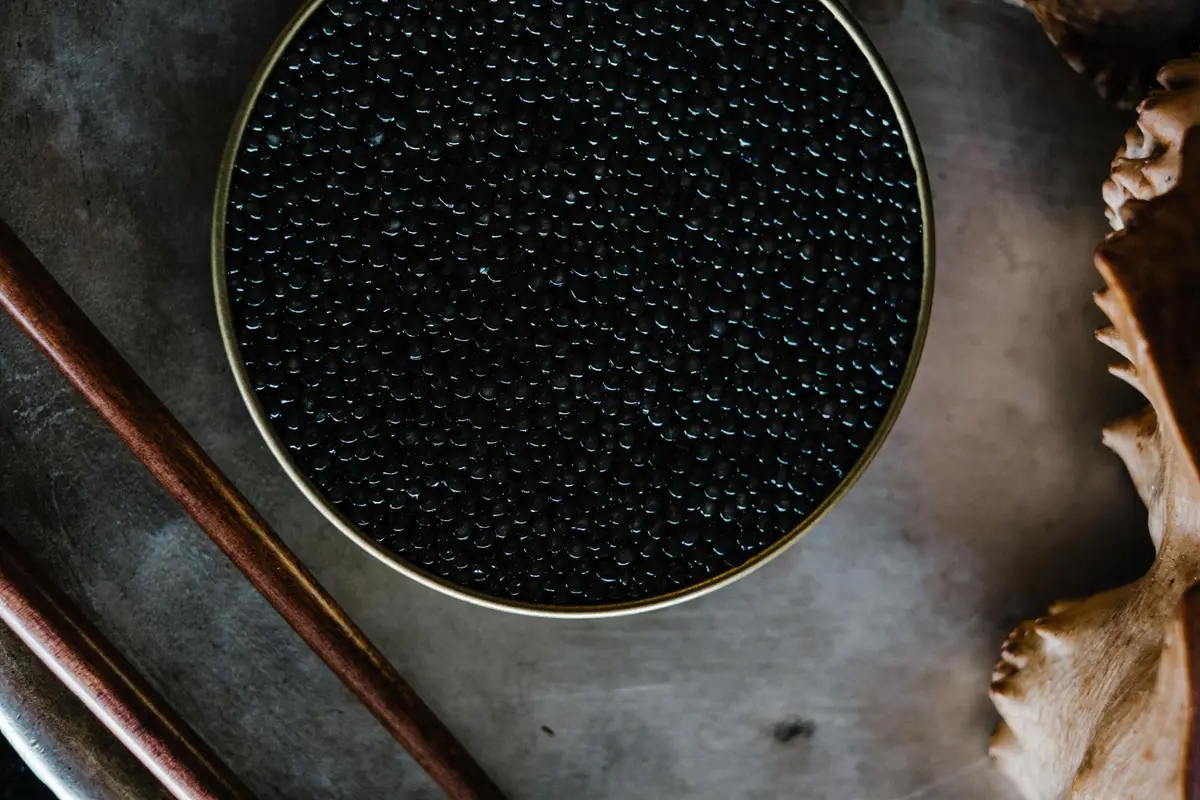 Open round tin of black caviar seen from above
